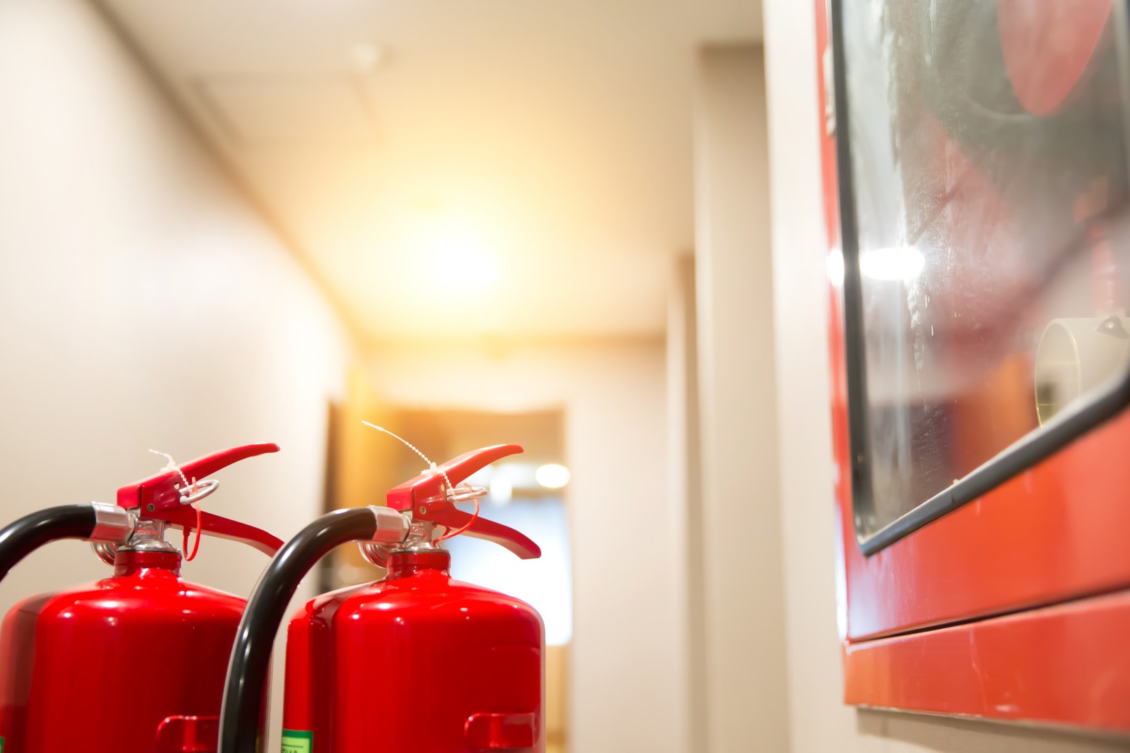 Red fire extinguisher tank in the building.